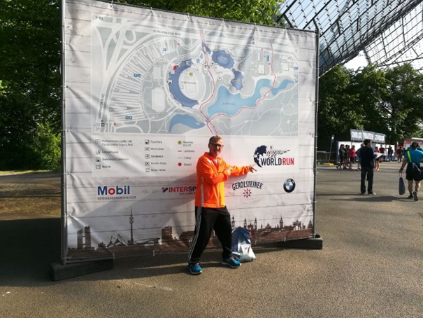 Läufer vor Plakat des Wing for Life World Run