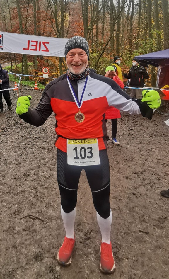 Läufer im Zielbereich mit Medaille um den Hals